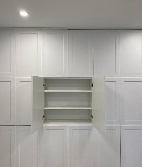 Custom white built-in storage cabinets with open
shelving